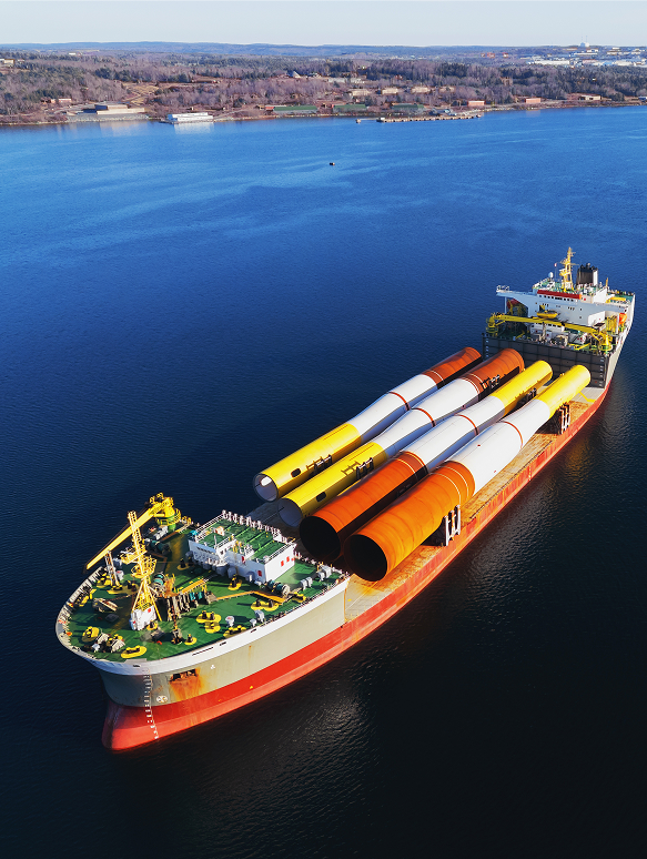 A large cargo ship navigating the ocean, representing Lofte's premium marine logistics and port services