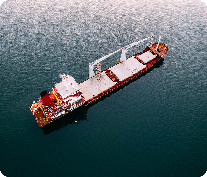 A large cargo ship navigating the ocean, representing Lofte's premium marine logistics and port services